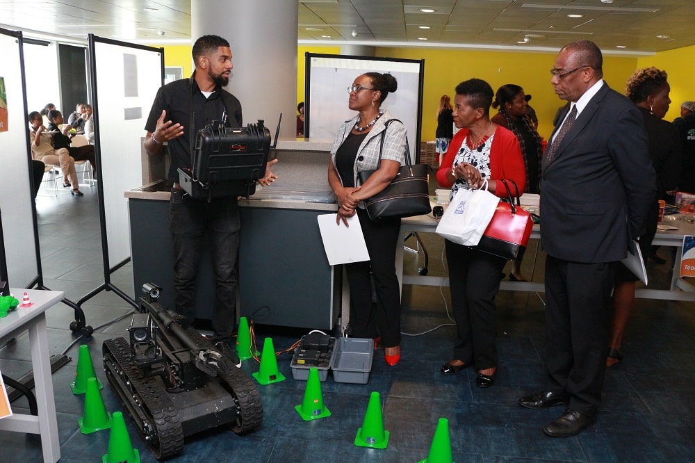 Senior Innovative Technician, Mr. Marvin Hollaway (left) demonstrates the use of the tactical robot used typically used to venture into areas which may be difficult or harmful to humans. Smaller tactical robots are also used for bomb disposals etc.